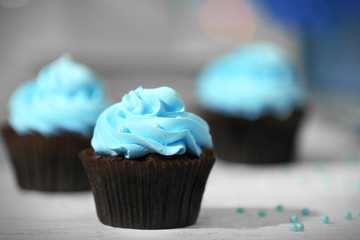 Chocolate cupcakes and flowers on a table