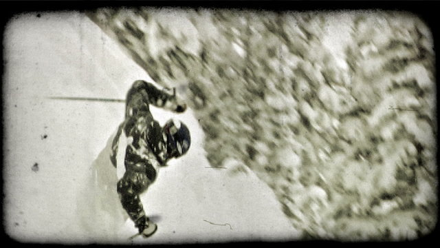 Expert skier skis down moutain. Vintage stylized video clip.