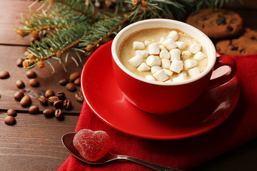 Obraz na płótnie Canvas Mug of hot chocolate with marshmallows, fir tree branch on wooden background