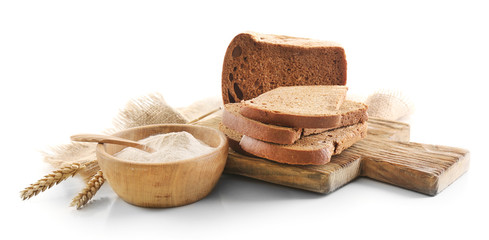 Sliced bread with ears and flour on napkin isolated on white
