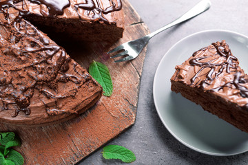 Sliced chocolate pie with mint on cutting board