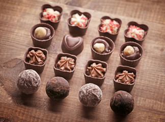 Set of chocolate candies on a wooden background
