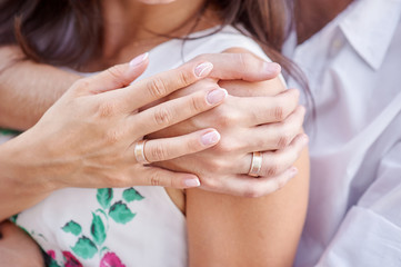 hands of bride and groom with rings close up