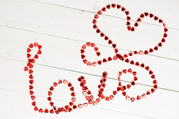 Word love of red string on the wooden table