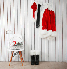 Obraz premium Santa red suit on a wooden white wall