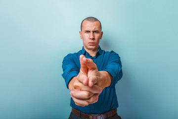a  man of European appearance thirty years  shows a finger gun o