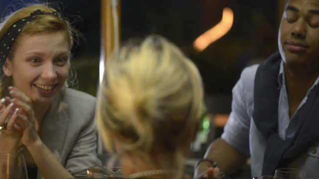 Friends in summer day evening are chattering at italian restaurant   