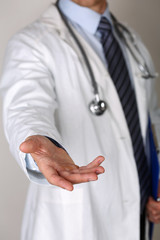 Male medicine doctor offering helping hand closeup