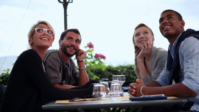 Friends are having fun chattering at italian restaurant