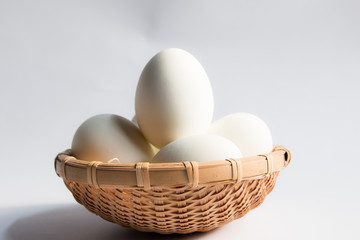 egg in basket wicker on white background,Duck eggs in baskets .