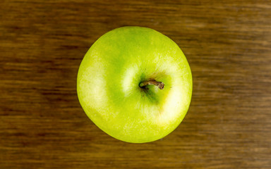 Aerial view of crisp green apple on rustic tabletop