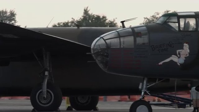 Pan from B-24 Liberator to B-25 Mitchell bombers from World War II parked side by side.  Recorded in 4K, ultra high definition.