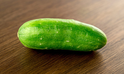 Organic mini cucumber on wooden board