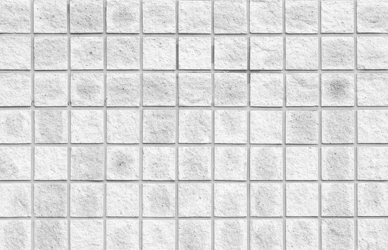 The modern white concrete tile wall background and texture..
