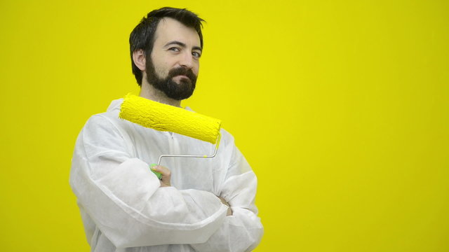 Man gesturing with a yellow paint roller