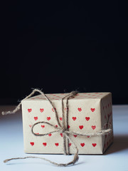 Present in Handmade Paper with Red Little Hearts Pattern