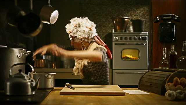 Funny Senior Housewife Is Cooking Vegetables In An Old Kitchen   