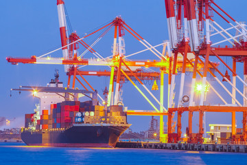 Cargo freight ship with stacked container at harbor terminal..