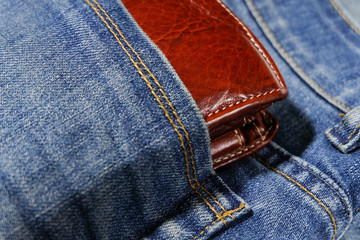 Wallet in a pocket blue jeans.