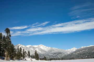 Winter blue sky with mountain top snow
