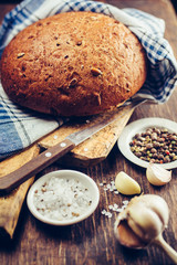 Fresh bread with spices on a dark background 