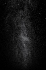 Abstract splashes and drops of water on black background.