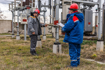 Electricians on high voltage substation