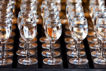 Glasses of vodka on wooden table