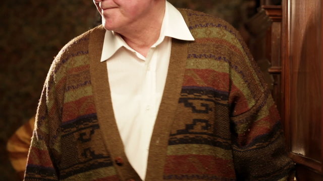 Senior couple indoor close up is eavesdropping on neighbour   