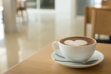 Hot art Latte Coffee in a cup on wooden table.