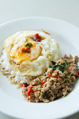 stir fried pork with basil leaf and deep fried egg, asian street