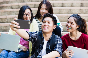 group of happy teen high school students outdoors