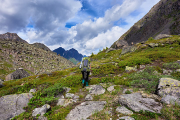 Fototapeta na wymiar Hiking. Woman walks on a mountain path