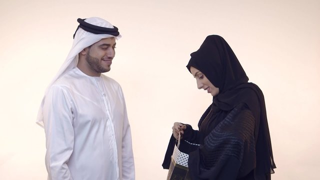 Emirati man giving gift to wife.