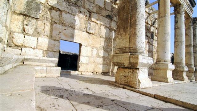 Slow-moving, angled tracking footage of ancient synagogue ruins