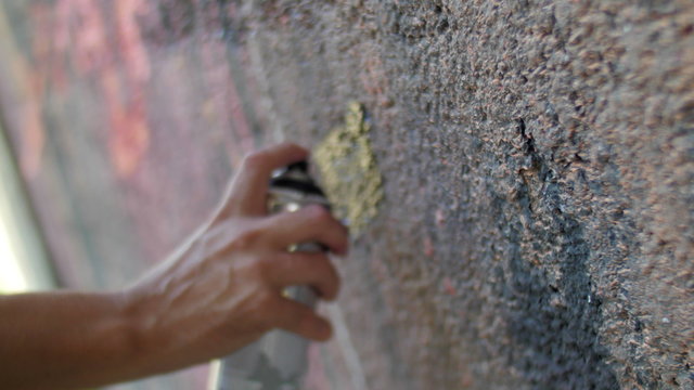 Writer painting with spray can closeup