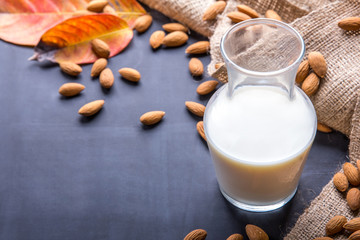 a bottle of almond milk with almonds around