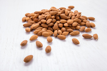 almonds in heap isolated on white background
