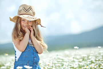 Happy little girl in a camomile field  © nuzza11