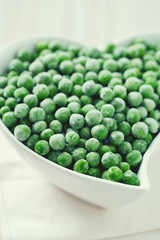 frozem peas on wooden surface