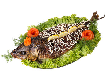 Baked sturgeon with greens and vegetables.