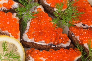Rye bread with butter and red caviar.
