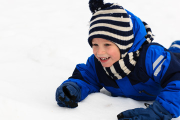 happy little boy having fun in winter