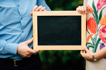 Close up of human hands holding blank frame