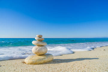 Stones balance, pebbles stack over blue sea in Croatia.