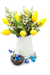 Easter setting with yellow tulips and chocolate eggs, toned