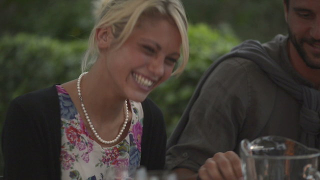 Woman at italian restaurant kiss on the cheek a man