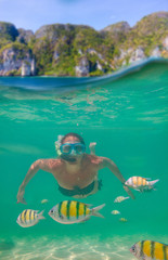 Young women at snorkeling in the tropical water