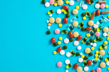 Colorful pills on blue background