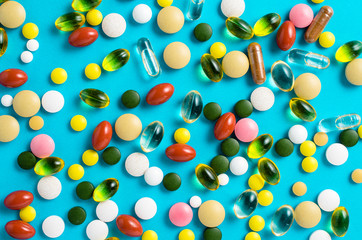 Colorful pills on blue background